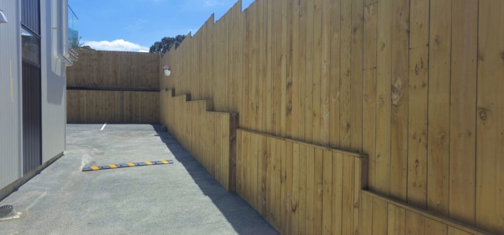 wo styles of timber fencing by Feature Fencing, showing a 1.8 m lapped paling fence with capping and post tops alongside a modern vertical slatted fence for a stylish and durable finish.